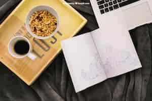 Free PSD book composition with coffee, cereals and laptop