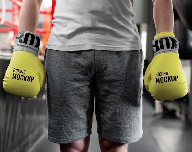 Boxing athlete wearing mock-up gloves to train