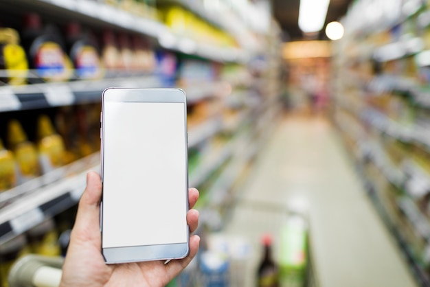 Browsing smartphone in supermarket 