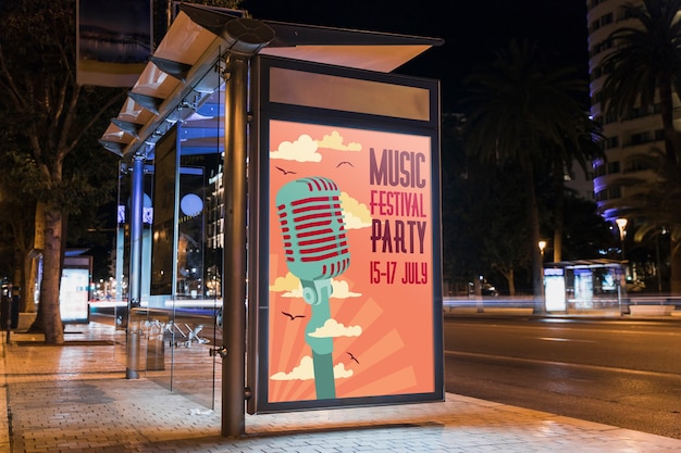 Bus stop billboard mockup in city at night