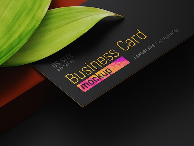 Business card on two leaves and a pencil mockup perspective view