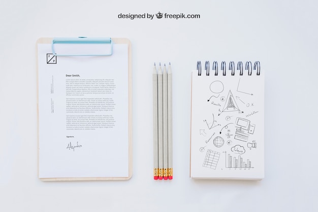 Free PSD business composition with clipboard, pencils and notebook