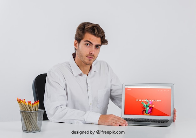 Free PSD businessman at desk with laptop