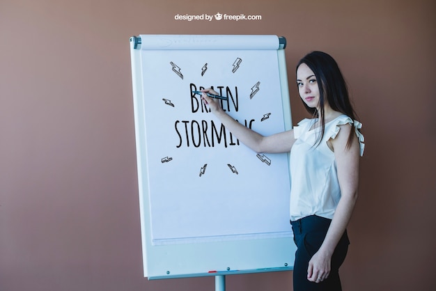 Businesswoman drawing on roll up banner