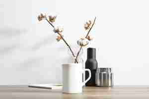 Free PSD ceramic mug and cotton plant inside flowerpot