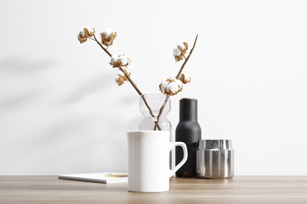 ceramic mug and cotton plant inside flowerpot