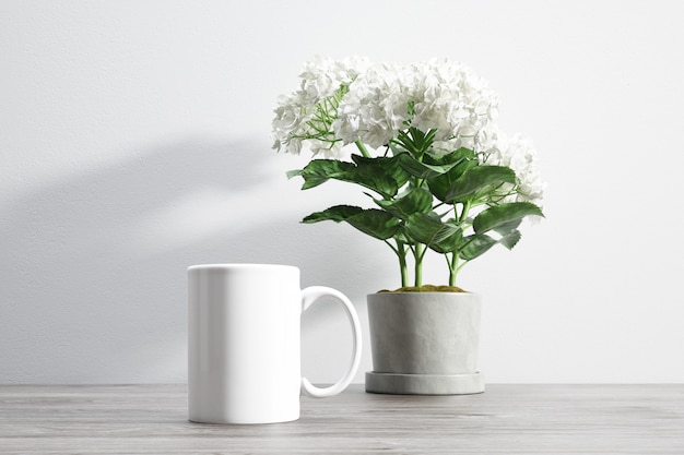 Ceramic mug and flower inside flowerpot