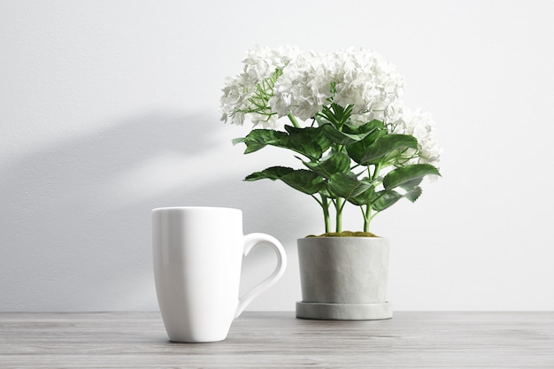 ceramic mug and flower inside flowerpot
