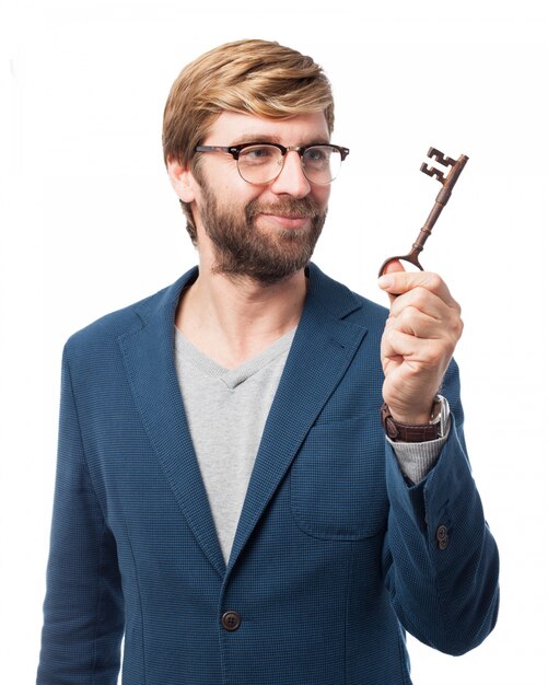 Cheerful businessman holding an old key