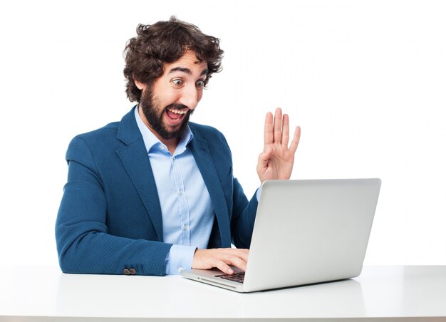 Cheerful employee working with his laptop