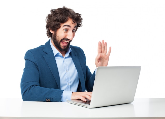 Cheerful employee working with his laptop