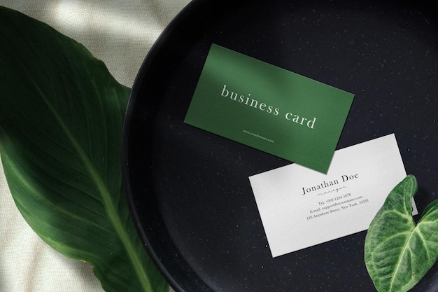 Clean minimal business card mockup on black stone plate