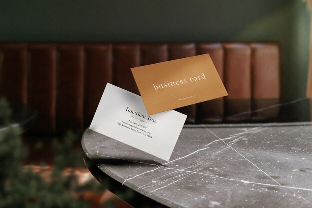 Clean Minimal Business Card Mockup Floating On Top Marble Table With Plant