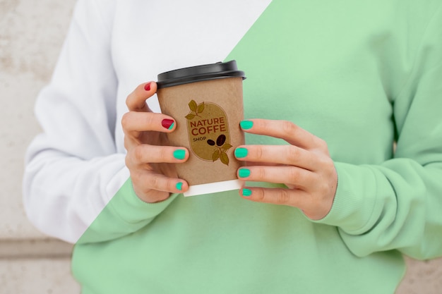 Close-up female with hoodie drinking coffee