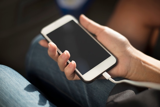 Close up of hands charging mobile phone