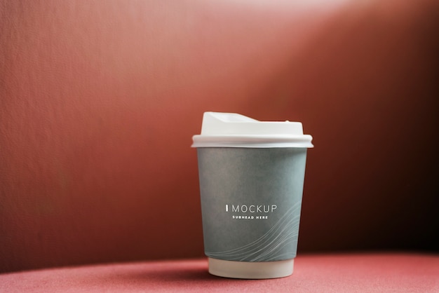 Free PSD coffee cup mockup in a red backdrop