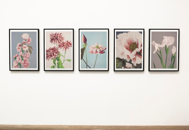 Collection of floral art pieces on a wall