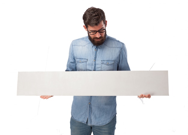 Concentrated boy holding an empty sign