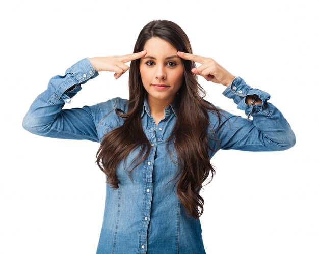 Concentrated young woman touching her forehead