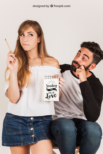 Couple holding notepad