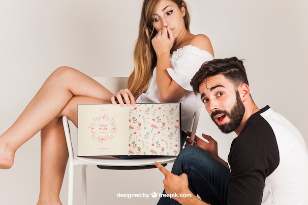 Couple presenting open book