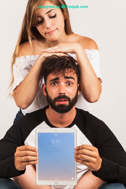 Couple presenting tablet