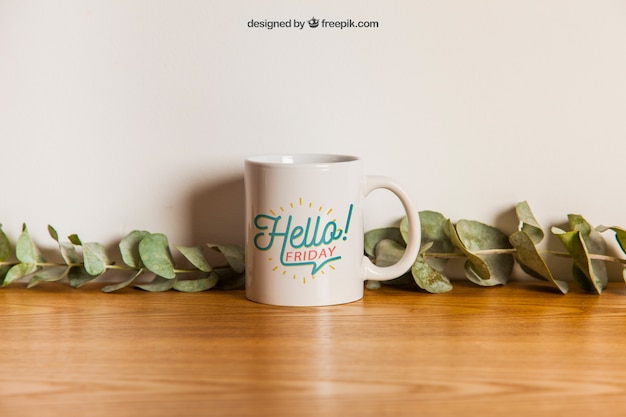 Free PSD cup mockup with floral decoration