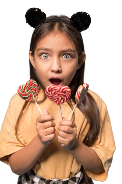 Cute girl holing candies happily