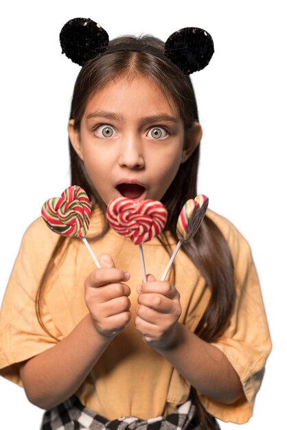 cute girl holing candies happily