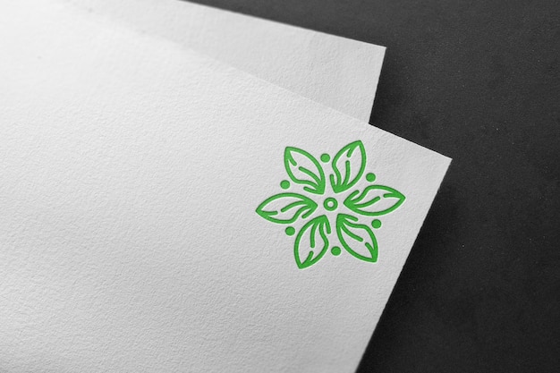 Debossed green logo mockup on white paper