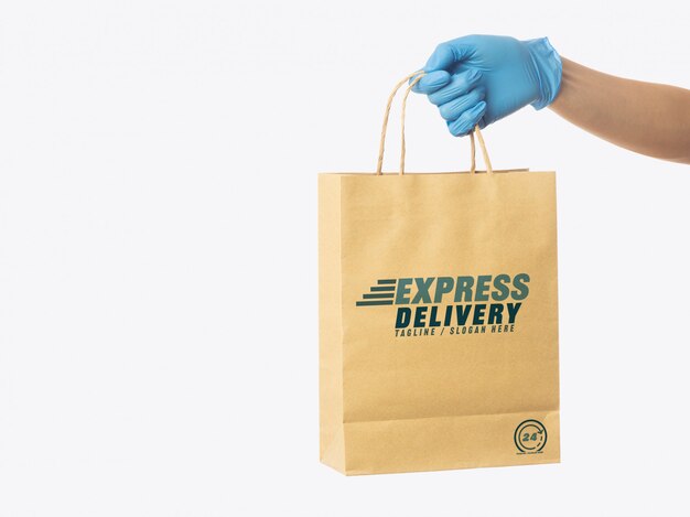 Download Premium Psd Delivery Man Hand Holding Craft Paper Shopping Bag Mockup Template Packaging Mockup Delivery Service Concept