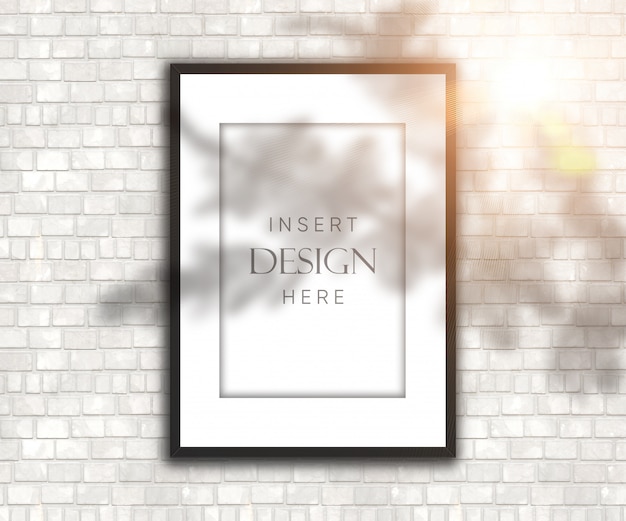 Editable blank picture frame on brick wall with shadow and sunshine overlay