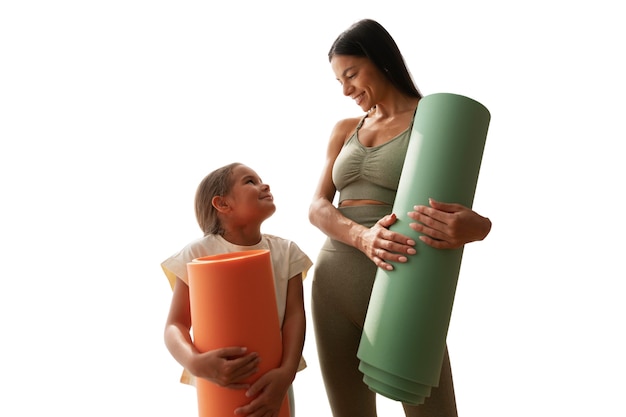 female yoga instructor doing meditation with young girl