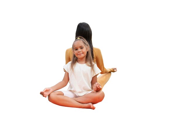 female yoga instructor doing meditation with young girl