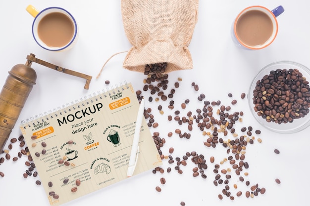 Flat lay mugs filled with coffee and grinder