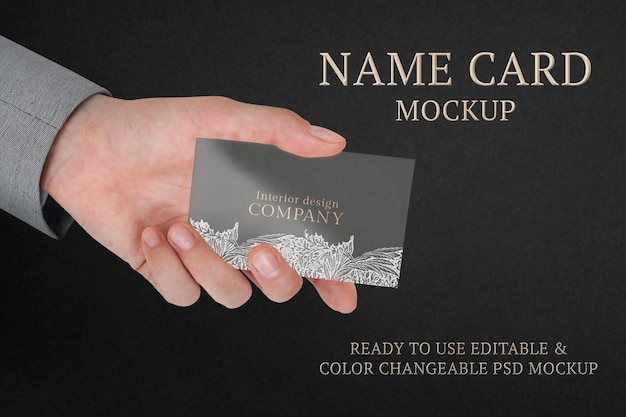 Floral business card mockup psd with businessman’s hand