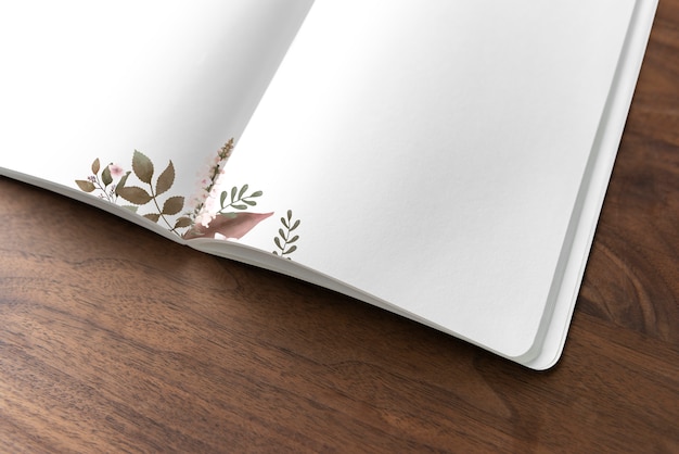 PSD gratuito mockup di notebook floreale su un tavolo di legno