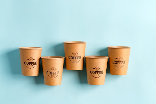 Download Premium PSD | Floating eco friendly paper disposable mockup cups above yellow background with ...