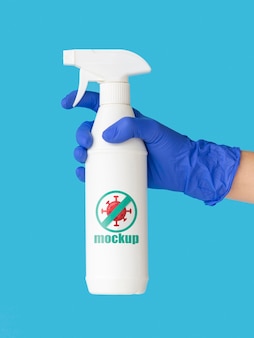 Front view hand with glove holding disinfection bottle mock-up