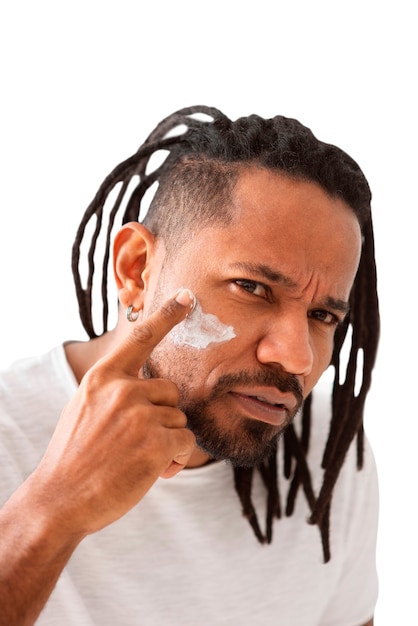 Free PSD front view man applying face cream