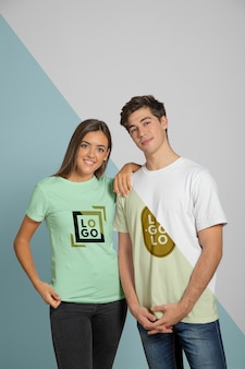 Front view of man and woman posing in t-shirts