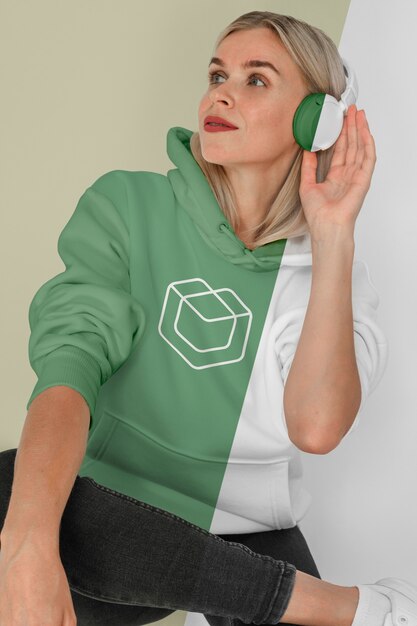 Front view of stylish woman in hoodie with headphones