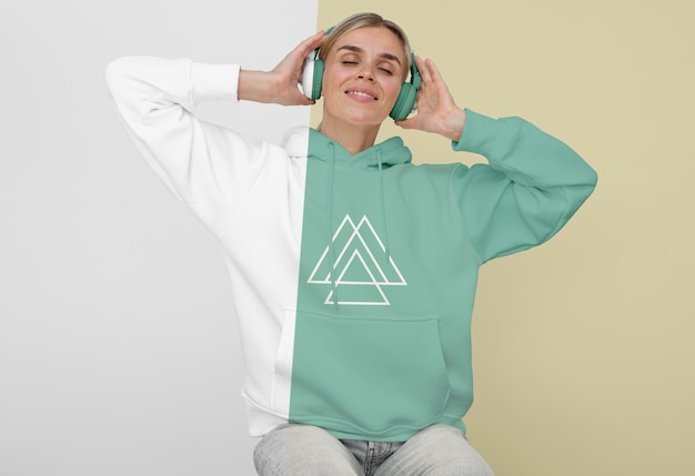 Front view of stylish woman in hoodie with headphones