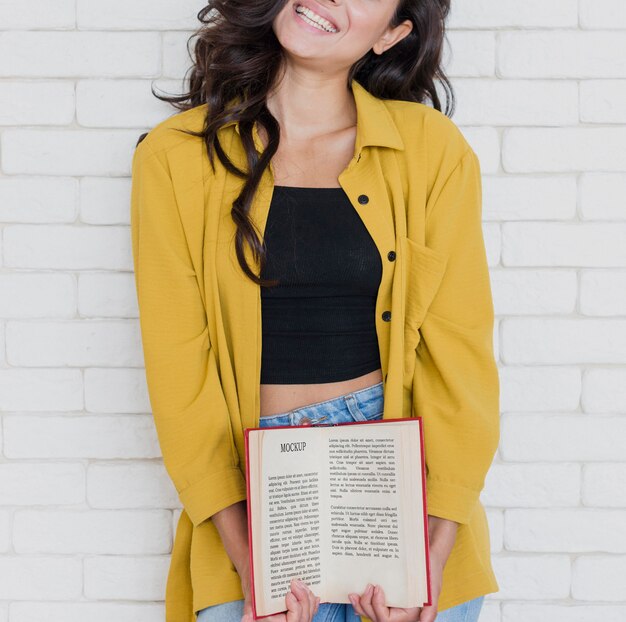 Front view woman holding a mock-up book