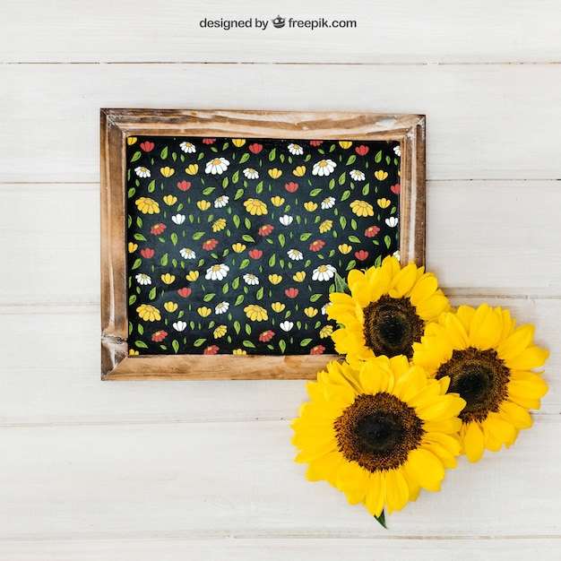 Free PSD gardening mockup with slate and three sunflowers