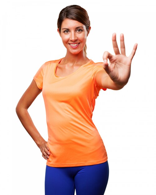 Girl in sportswear showing positive gesture