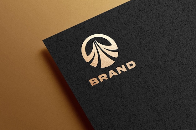 Golden logo mockup embossed on black paper