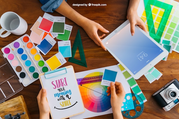 Graphic designer mockup with hands holding tablet