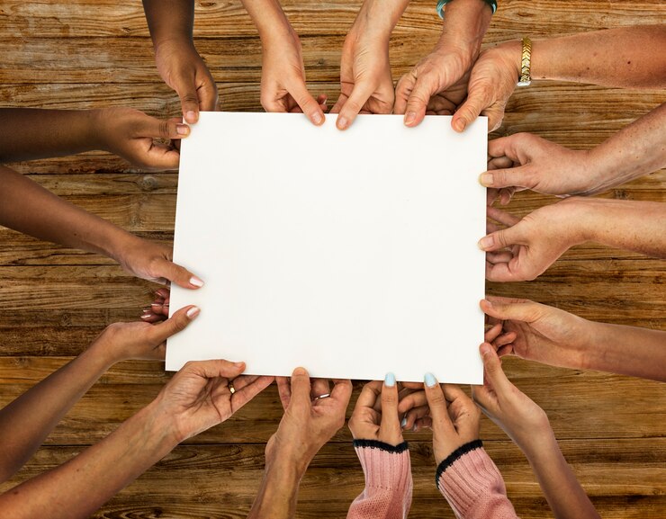 Free PSD group of diversity hands holding empty paper