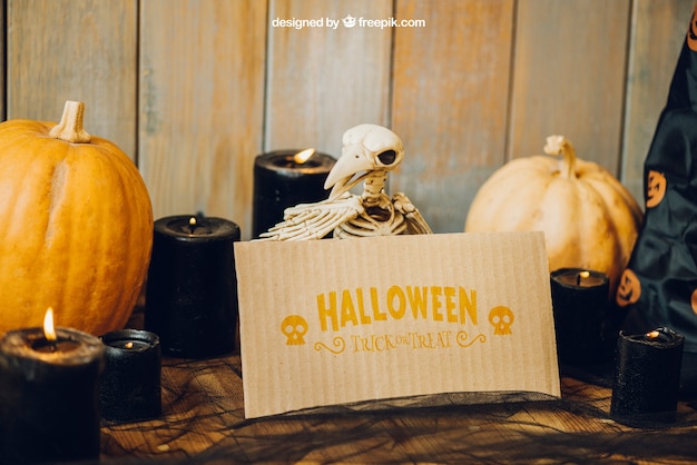Free PSD halloween mockup with bird skeleton and card